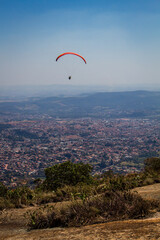 A person paragliding across the sky.