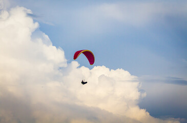 A person paragliding across the sky.