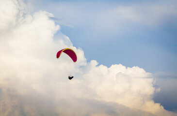 A person paragliding across the sky.