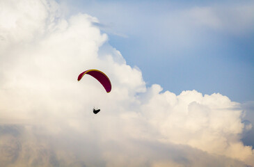 A person paragliding across the sky.