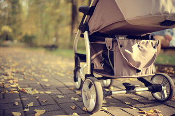 stroller view from the back legs, mom walk autumn abstract background fragment