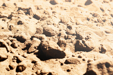 Sand under bright sun and harsh shadows