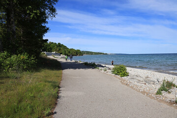 Fototapeta na wymiar The bike path in Magnus Park in Petoskey, Michigan is right along the shore of Lake Michigan.