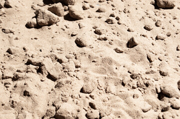 Sand under bright sun and harsh shadows