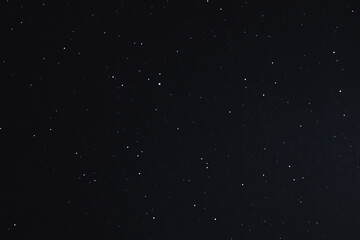 The night sky is filled with tiny glowing stars, scattered across a deep black canvas. The stillness and purity of the scene evoke wonder and reflection. 