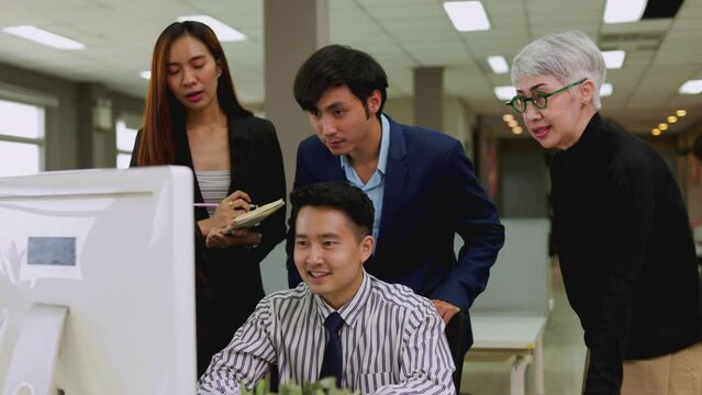 Asian business team celebrates their economic success.