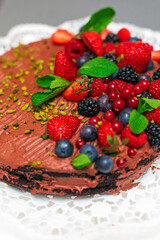 Delicious vegetarian chocolate cake with berries and pistachio  - 526317332