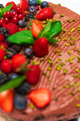 Delicious vegetarian chocolate cake with berries and pistachio 