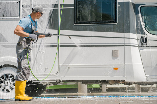 Man Pressure Washing His RV