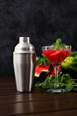 watermelon alcoholik or non- alcoholic cocktail with mint on dark background