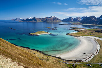 Bay with crystal clear turquoise waters and white sand at Yttersand in Lofoten, Norway