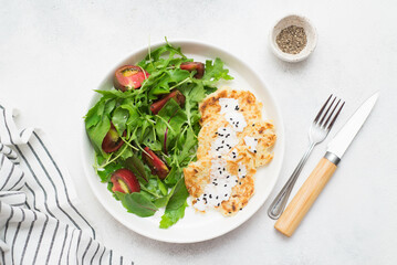 Homemade zucchini pancakes with light vegetable salad