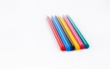 Colored pens lie on a white background concept. Education. Background. School. Isolated