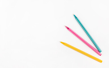 Colored pens lie on a white background concept. Education. Background. School. Isolated