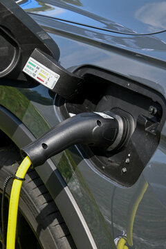 Lyss, Berne, Switzerland, august 27, 2022, E-mobility car show, Electric car at charging station with the power cable supply plugged