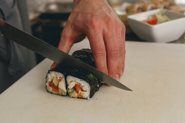 Close up of man japanese restaurant chef cooking sushi in the kitchen 