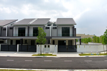 Fototapeta na wymiar SELANGOR, MALAYSIA - JUNE 18, 2022: New double-story terrace house under construction in Malaysia. This house has a wide front porch and is fenced. Has basic facilities.