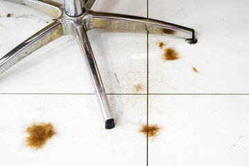 red hair on the barber shop floor and chair legs