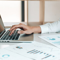 Financial businessmen use laptop to analyze marketing strategies and real estate data to reduce company taxes for their customers, Accounting and Tax concept.