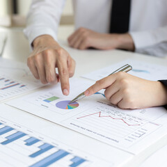 President and the marketing staff of the company convened the earnings revenue and analysis of real estate data graph in the office, Brainstorming ideas about finance and accounting concept.