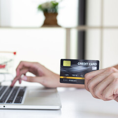 Men use laptop to register online purchases using credit card payments, Convenience in the world of technology and the internet, Shopping online and banking online concept.