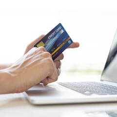 Men use laptop to register online purchases using credit card payments, Convenience in the world of technology and the internet, Shopping online and banking online concept.