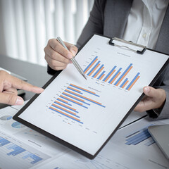 Brainstorm team, Marketers and financial accountants are discussing and analyzing charts to plan...