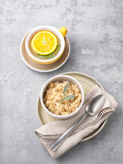 Oatmeal porridge on light stone background