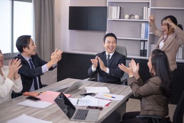 Business people meeting and discussing documents and ideas at meeting around table.