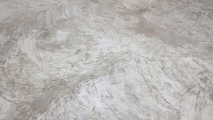 The stains of cement on the polished concrete floor.