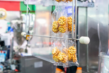 Sandwich cookies biscuits with pineapple jam after process fill to plastic pouch bag and seal by continuous vertical automatic packing machine for industrial