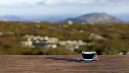 Hot coffee cup on wooden table with blur natural mountain view background.