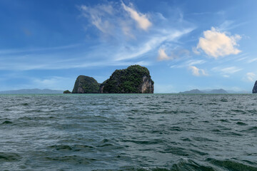 Phangna Bay near the Island of Phuket Thailand. Lovely rock in the middle of the ocean surrounded by mountains