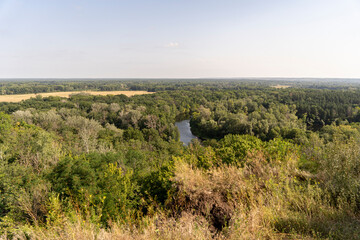 Fototapeta na wymiar Landscape of wildlife forest and curved river from a high hill