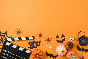 Halloween party concept . Horror movie night background  with   pumpkin, decorations and movie clapperboard. Top view, flat lay