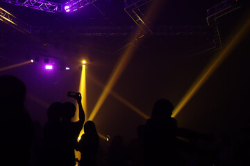 Fototapeta na wymiar Shadows of people in a music Club and lights