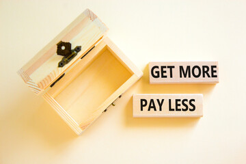 Get more pay less symbol. Concept words Get more pay less on wooden blocks on a beautiful white table white background. Empty wooden chest. Business Get more pay less concept. Copy space.
