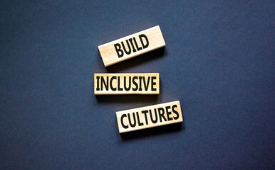 Build inclusive cultures symbol. Concept words Build inclusive cultures on wooden blocks. Beautiful black table black background. Business build inclusive cultures concept. Copy space.