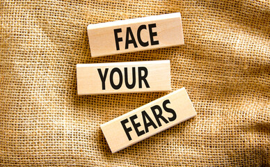Face your fears and support symbol. Concept words Face your fears on wooden blocks on canvas. Beautiful canvas background. Business and Face your fears quote concept. Copy space.