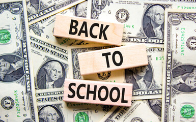 Back to school and support symbol. Concept words Back to school on wooden blocks on dollar bills....