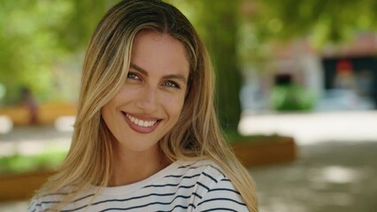 Young blonde woman smiling confident standing at park - Powered by Adobe