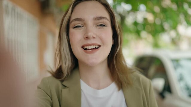 Young woman business worker having video call at street