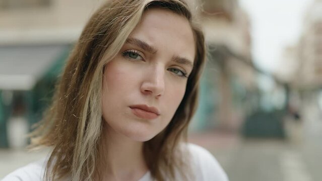 Young woman with relaxed expression standing at street