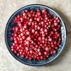 a plate with frozen red currants on a light table