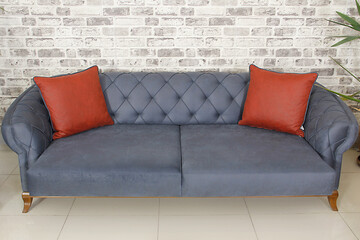 navy blue sofa and red pillows