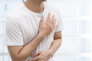 Man clutching his chest from acute pain.Heart attack symptom.