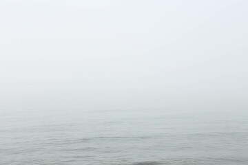 Seascape in fog. Abstract background in the form of a blue sea in the fog. Free space for text.