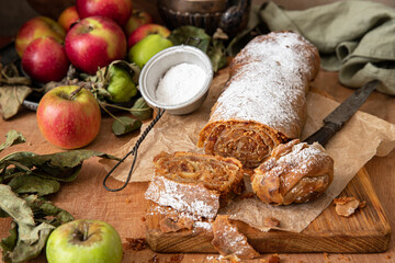Homemade traditional Apple strudel on a wooden background
