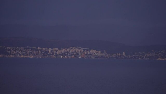 Stormy sky over Kvarner Bay across to Rijeka at dusk from Lovran, Kvarner Bay
