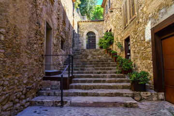 Fototapeta na wymiar Narrow alley with stairs in the medieval town of Besalu on the Costa Brava, Girona Spain.